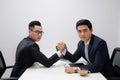 Two businessmen competing arm wrestling in office Royalty Free Stock Photo