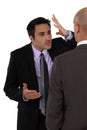 Two businessmen disagreeing