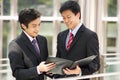 Two Businessmen Discussing Document Outside Office