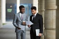 Two businessmen examining contract outdoors