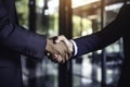 Two businessmen in formal attire shaking hands in front of a modern office building, AI-generated. Royalty Free Stock Photo