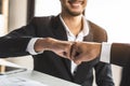 Two businessmen giving fist bump after project successful