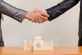 Two businessmen hands in elegant suits handshake