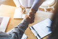 Two businessmen handshaking in meeting after final project agreement deal done