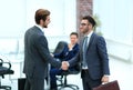 Two businessmen handshaking after striking grand deal Royalty Free Stock Photo