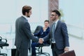 Two businessmen handshaking after striking grand deal Royalty Free Stock Photo