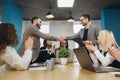 Two businessmen handshaking after striking grand deal in office Royalty Free Stock Photo