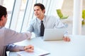 Two Businessmen Having Meeting Around Table In Modern Office Royalty Free Stock Photo