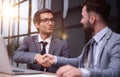 Two Businessmen Having Meeting Around Table In Modern Office Royalty Free Stock Photo