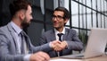 Two Businessmen Having Meeting Around Table In Modern Office Royalty Free Stock Photo