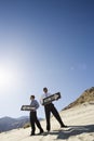 Two Businessmen Holding One Way Signs in the Desert Royalty Free Stock Photo