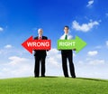 Two Businessmen Holding Wrong and Right Royalty Free Stock Photo