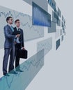 Two businessmen looking at shining chart. Royalty Free Stock Photo