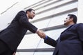 Two businessmen meeting outside office building