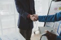 Two businessmen shake hands after a joint meeting, business venture handshake saluting, business meeting, presentation of business Royalty Free Stock Photo