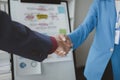 Two businessmen shake hands after a joint meeting, business venture handshake saluting, business meeting, presentation of business Royalty Free Stock Photo