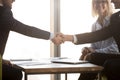 Satisfied business partners in suits shake hands, close up view Royalty Free Stock Photo