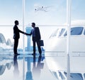 Two Businessmen Shaking Hands In An Airport Royalty Free Stock Photo