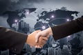 Two businessmen shaking hands on a background map Royalty Free Stock Photo