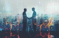 Two Businessmen Shaking Hands in Front of City Background Royalty Free Stock Photo