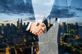 Two businessmen shaking hands on night city background. Teamwork, success and partnership concept. Double exposure Royalty Free Stock Photo