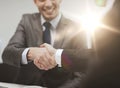 Two businessmen shaking hands in office