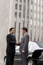 Two businessmen shaking hands outdoors