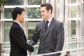 Two Businessmen Shaking Hands Outside Office