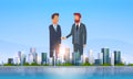 Two businessmen shaking hands partners successful agreement business deal hand shake concept over big modern city Royalty Free Stock Photo