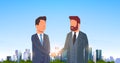 Two businessmen shaking hands partners successful agreement business deal hand shake concept over big modern city Royalty Free Stock Photo