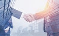 Two businessmen shaking hands, skyscrapers Royalty Free Stock Photo