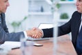 Two businessmen shaking hands and working Royalty Free Stock Photo