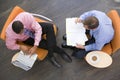 Two businessmen sitting indoors having a meeting