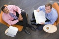 Two businessmen sitting indoors having a meeting