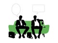 Two businessmen speaking seated on green sofa