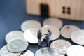 Two businessmen standing in the coin and shake hand and deal business on selling house with blurred background Royalty Free Stock Photo