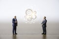 Two businessmen standing and discussion with cog gears. Brainstorming idea concept Royalty Free Stock Photo