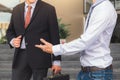 Two businessmen standing talking outside office, Business partners meeting Royalty Free Stock Photo