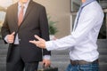 Two businessmen standing talking outside office, Business partners meeting Royalty Free Stock Photo