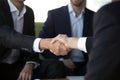 Two businessmen in suits shake hands at meeting, close up Royalty Free Stock Photo