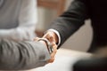 Two businessmen in suits shaking hands at meeting, close up Royalty Free Stock Photo