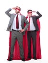 Two businessmen in superhero raincoats looking in different directions.