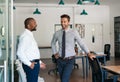 Two businessmen talking and laughing together in an office Royalty Free Stock Photo