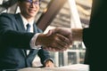 Two businessmen are talking and making deals on business operations and agreeing by shaking hands in the office Royalty Free Stock Photo