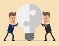 Two businessmen unite lamp of the puzzle. Joining forces, the birth of a new idea . Collaboration concept. Completing business i Royalty Free Stock Photo