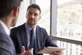 Two Businessmen Using Digital Tablet In Office Meeting Royalty Free Stock Photo