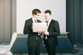 Two businessmen using laptop together Royalty Free Stock Photo
