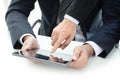 Two businessmen using tablet computer with one hand touching screen Royalty Free Stock Photo