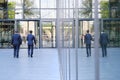 Two businessmen walk along the square to the business center