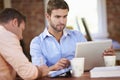 Two Businessmen Working At Desk Together Royalty Free Stock Photo